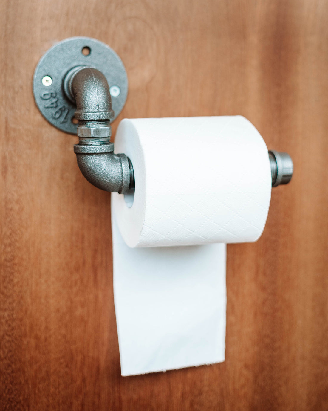 Toilet Roll Holder mounted on the wall, showcasing its sleek and practical design.